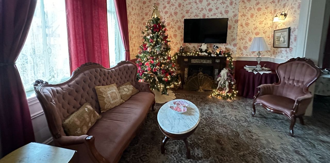 Kintner House Inn Corydon Indiana - Historic 1873 bed and breakfast parlor decorated for Christmas with elegant Victorian furnishings and festive holiday decorations